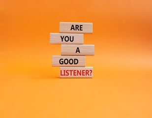 Listening skills symbol. Wooden blocks with words Are you a good Listener. Beautiful orange...