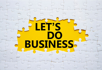 Lets do business symbol. Concept words Lets do business on white puzzle. Beautiful yellow...