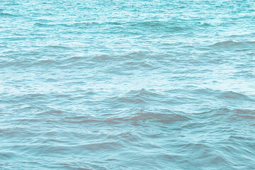 The sea surface has small waves reflecting light.