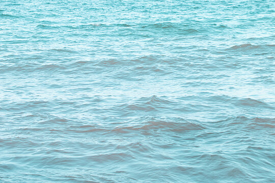 The sea surface has small waves reflecting light.