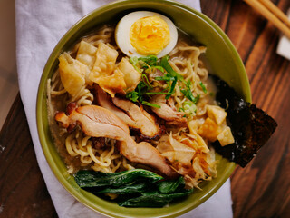 Toripaitan ramen in a bowl, with egg, vegetable, grilled chicken and nori