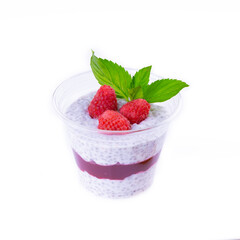 chia pudding with raspberry sauce, granola and fresh raspberries on rusic background