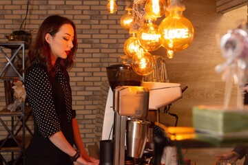 Young Female Barista Contemplating Beside Espresso Machine in Cozy Cafe Setting