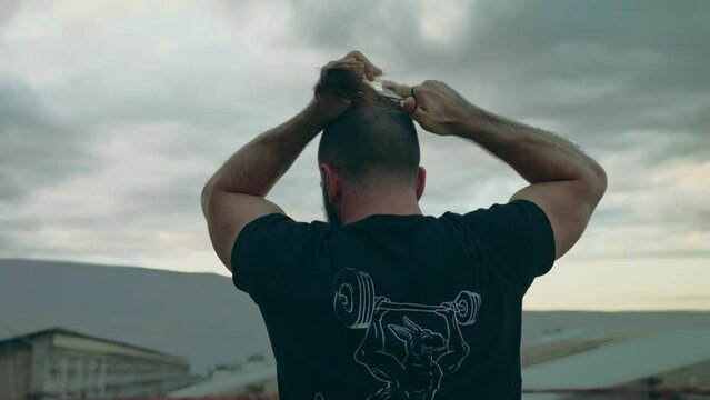 A Fitness man fixes hair