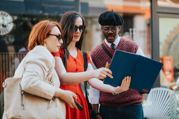 A diverse group of friends engage in conversation outdoors, enjoying a sunny day and each other's...