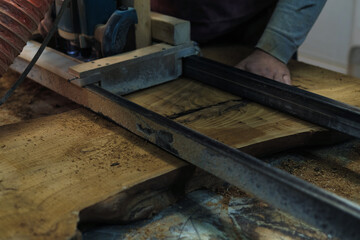 The woodworker carefully cuts through the timber, shaping a future piece of art. Every cut is a...