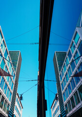 Low angle view of buildings and a window with reflection of the buildings