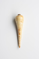 Top view of a fresh parsnip isolated on a white background. Parsnip (Pastinaca sativa) is a root vegetable closely related to carrot and parsley, all belonging to the flowering plant family Apiaceae.