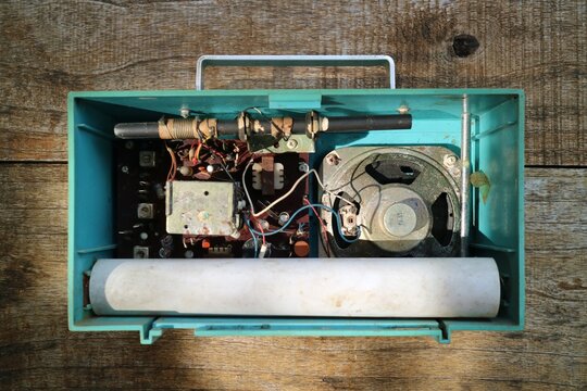 old transistor radio machine on wooden table, electric device interior