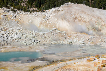shiny blue little pond of hot smoking water at the Bumpass hell in lassen volcanic national park,...