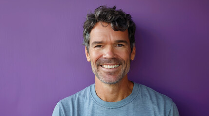 Obraz premium A man with a blue shirt and gray hair is smiling at the camera