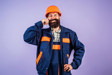 Portrait worker in construction helmet. Builder foreman or repairman in builder uniform. Worker in studio. Construction manager, builder in helmet. Male builder engineer.