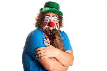 Funny fat clown with a small dog posing on a white background.