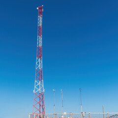 tall Telecommunication towers with blue sky background