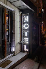 Illuminated 3d Letters Vertical Hotel Sign Glow at Night