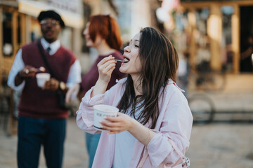 Young friends hang out and enjoy ice cream on a sunny weekend, embodying freedom and city life enjoyment.