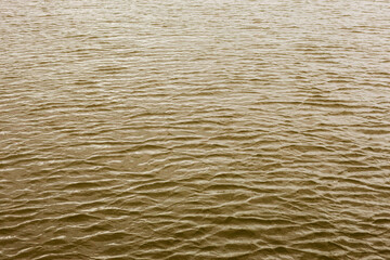 the surface of the water, taken on a cloudy windy evening