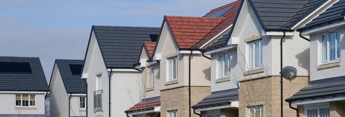 New housing development and owners cars parked outside