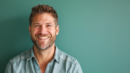 Fototapeta premium A man with a beard and a smile is smiling at the camera