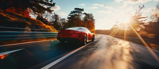 a red sports car is driving on the highway with beautiful natural views