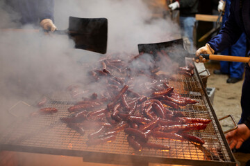 Chorizos roasting on a barbecue at the Fachós de Castro Caldelas festival