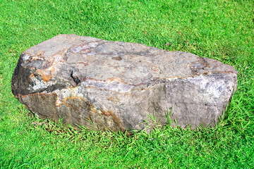 stones on a green lawn background