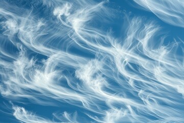 The sky is filled with clouds that look like they are blowing in the wind. The clouds are white and fluffy, and they are scattered throughout the sky