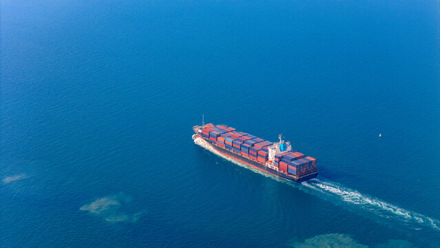 Top view Container ship full capacity approaching the port International Container ship loading, unloading at sea port, Freight Transportation, Shipping,  