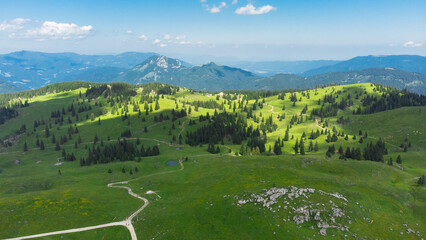 Aerial View of Mountain Cottages on Green Hill of Velika Planina Big Pasture Plateau, Alpine Meadow...