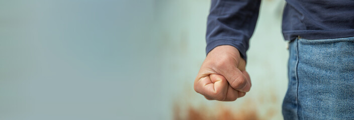 Man clenches his fist tightly in anger, hand close up, emotion concept, stock photo