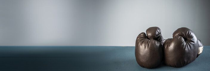 black boxing gloves, studio settings, sports concept stock photo, blue, gray background