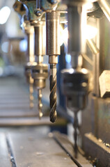 A hand holding shredded raw denim fabric in a denim factory. Industrial fabric and fashion manufacture. Stylish blue denim fabric for wholesale and jean recycling.