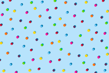 Multicolored candies on a bright blue background. Concept of candy. Colorful background.