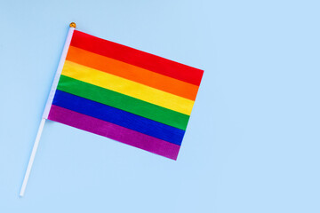 LGBT rainbow flag flat lay on light blue color background. gay marriage, human rights, june parade,...
