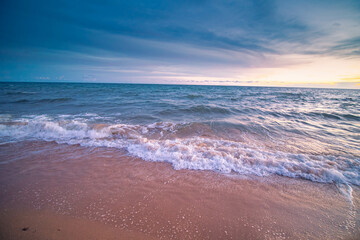 Aerial panorama of Thailand's verdant with blue and aquamarine the sea, and clouds shining by sunlight in the background.