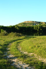 A dirt path leading to a hill