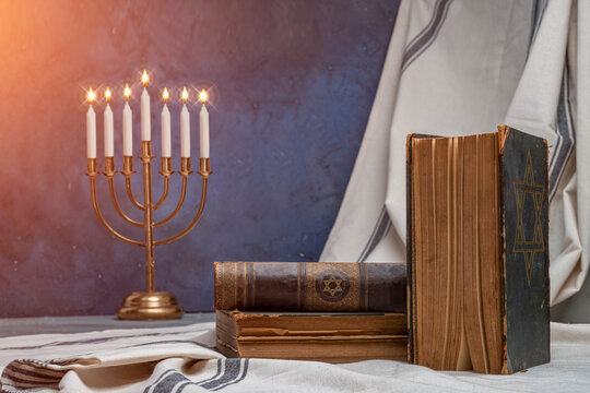 Old book Talmud, Hebrew Rabbinic Judaism, Jewish religious law. Torah, Hebrew Bible. Menorah, Star of David on a dark cover. Holy Scripture, word of God. Antique edition, vintage worn paper