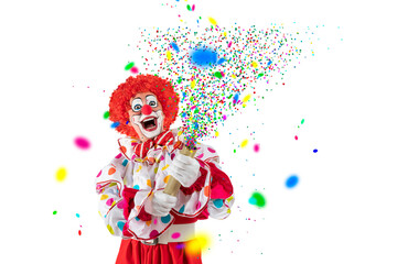 Fototapeta premium Funny clown pulling carnival cracker. Entertainer Joker in colorful suit and wig.Trickster, jester, pantomime, mime whiteface makeup. Professional actor at event, kids party, circus