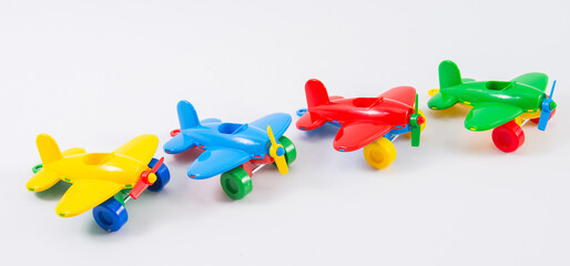 Children's plastic multi-colored airplane on a white background.