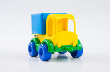 Plastic toy multi-colored truck on a white background.