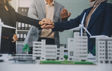 Two business executives, elegantly attired in suits, join hands in a gesture of unity, solidarity,...