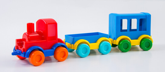 Plastic toy train with carriages on a white background.