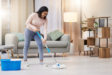Happy, woman and cleaning floor in home with mop for hygiene with detergent for safety or...