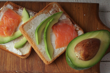 Toast with avocado and red fish. An exquisite breakfast of toast and flowers