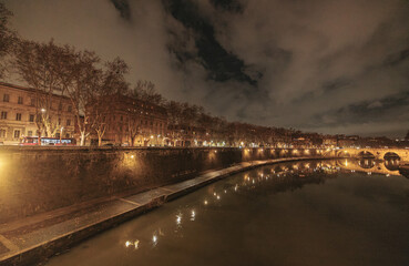The moon shines brightly in the night sky, casting a soft glow on the tranquil river below. A...