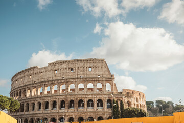 The colossal Roman Colosseum stands tall and grand in Rome, Italy, showcasing its timeless beauty and historical significance. Tourists marvel at its intricate architecture and imposing presence