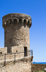 Beautiful view of the fortress against blue sky. Tossa de Mar. Spain.