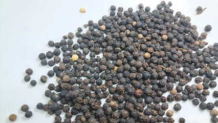 pile of black pepper seeds isolated on white