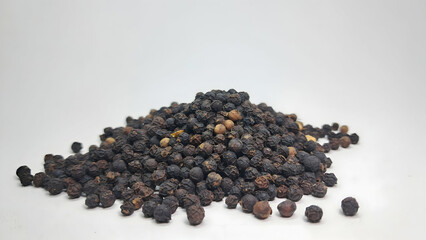 pile of black pepper seeds isolated on white