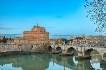 A grand bridge stretches over a serene river, leading to a magnificent castle nestled in the...